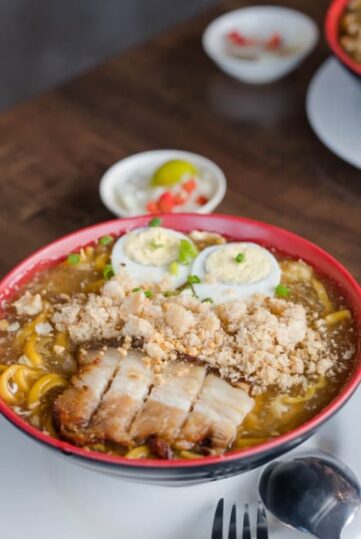 Lomi topped with pork slices